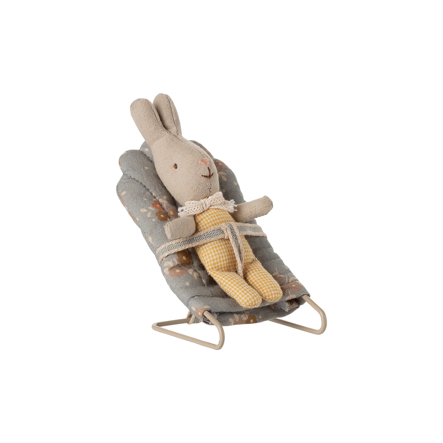 Stuffed rabbit toy in a gray baby bouncer on a white background