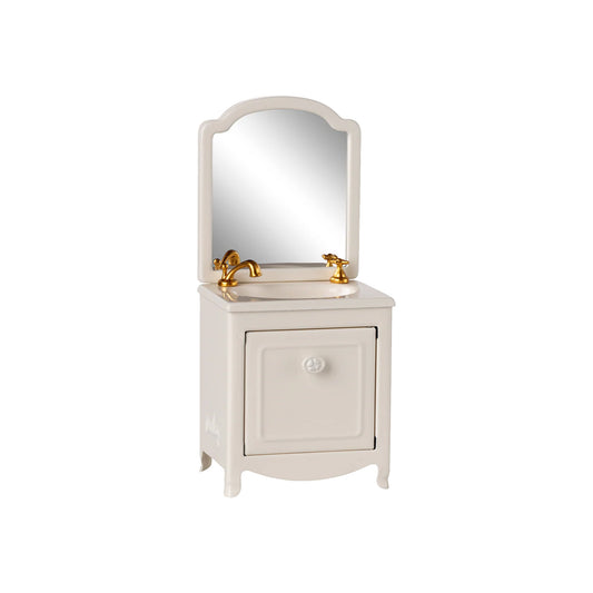 White bathroom vanity with mirror and gold fixtures on a white background