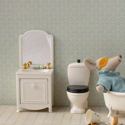 Children's bathroom set with sink, toilet, and bathtub featuring a teddy bear.