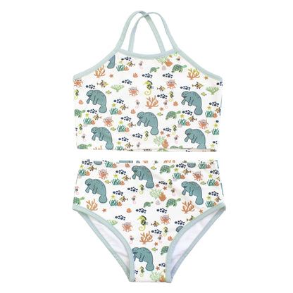 Two-piece swimsuit with manatee and coral pattern on a white background