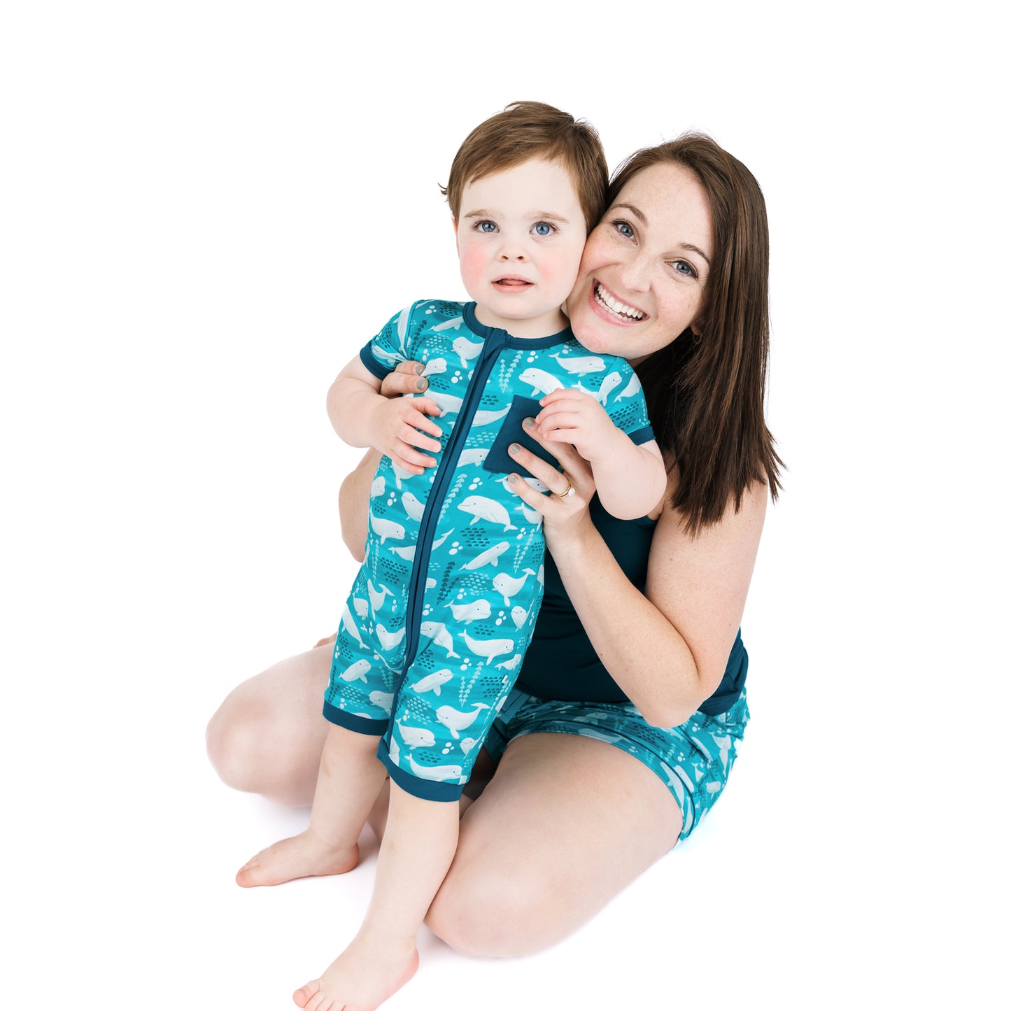 Mother and son matching in our Bamboo Beluga whale pajamas in a white background