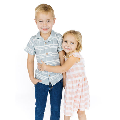 Siblings matching in a blue plaid and pink gingham prints