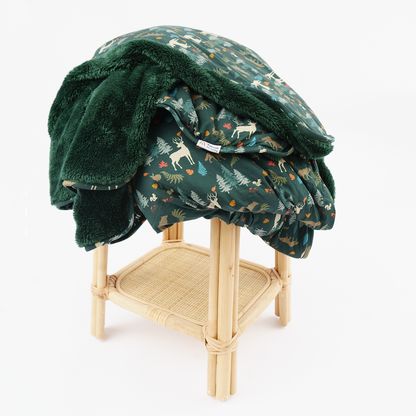 dark green blanket with forest animal print and dark green fleece