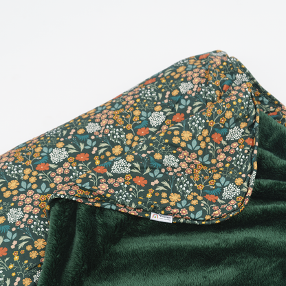 dark floral print blanket with dark green fleece.