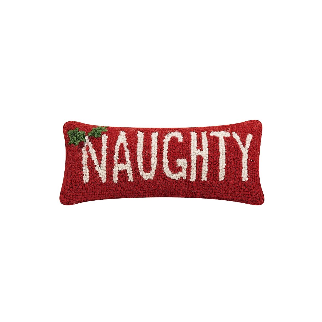 Small red pillow with the word naughty in white lettering