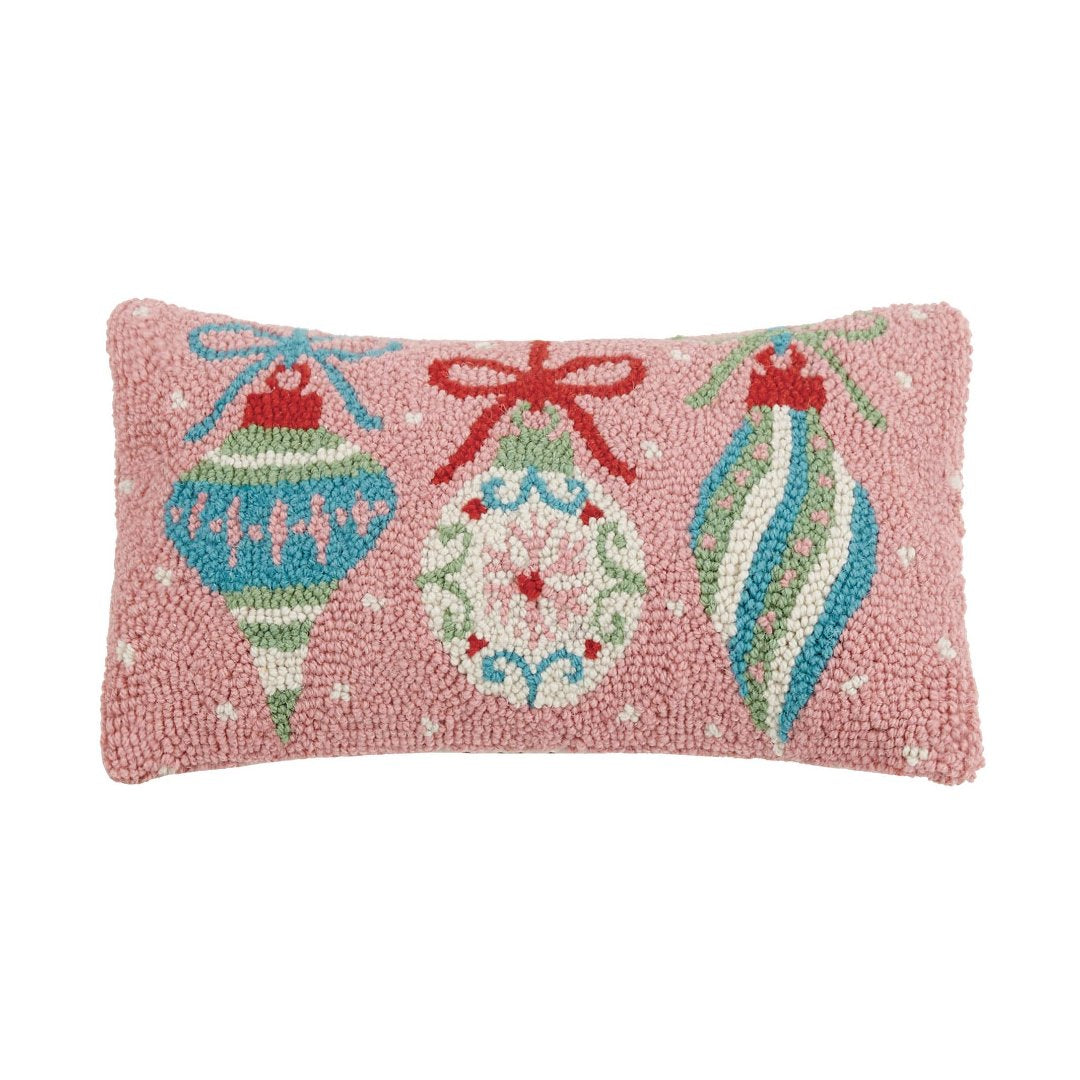 Pink pillow with three decorative ornaments