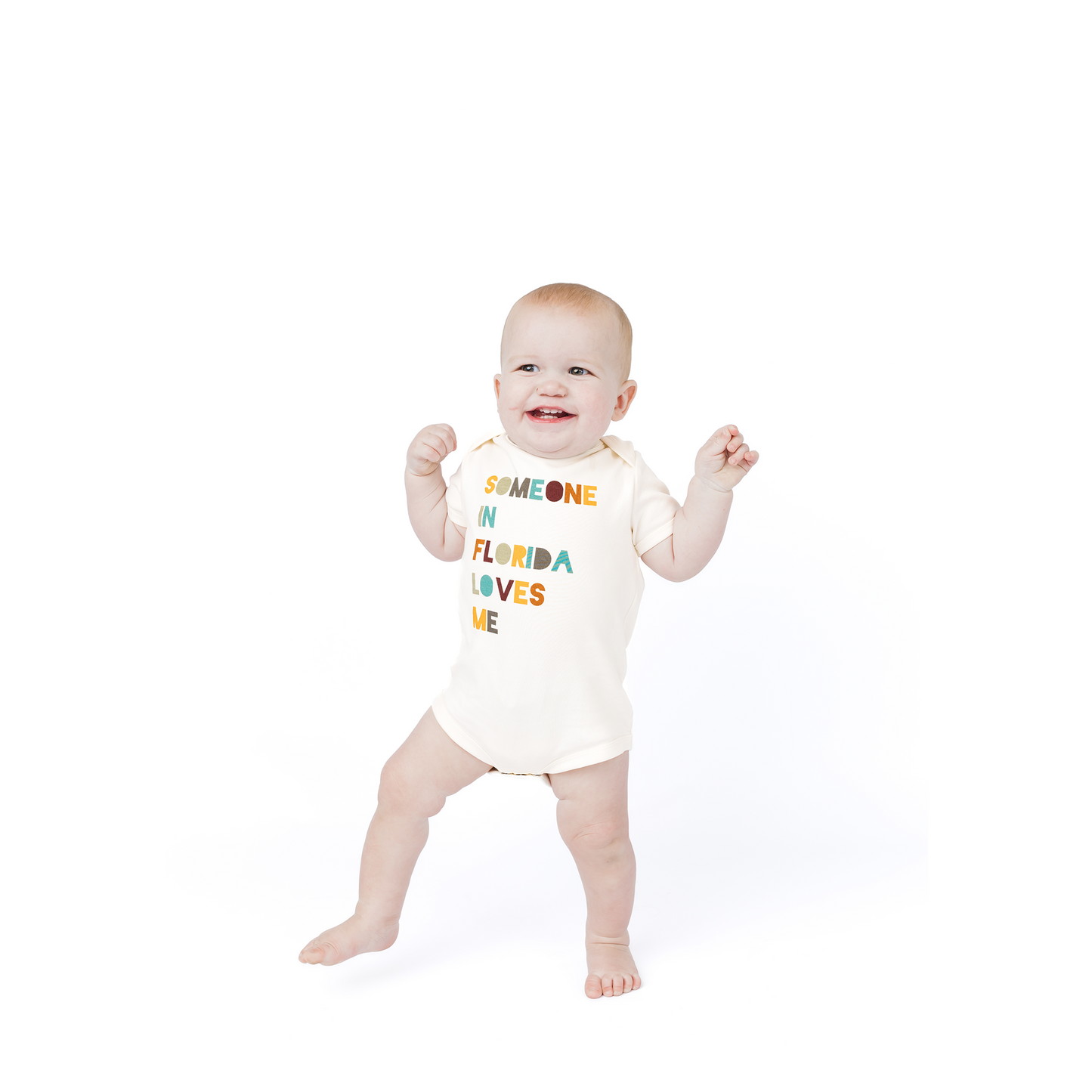 Baby wearing a onesie with text on a white background