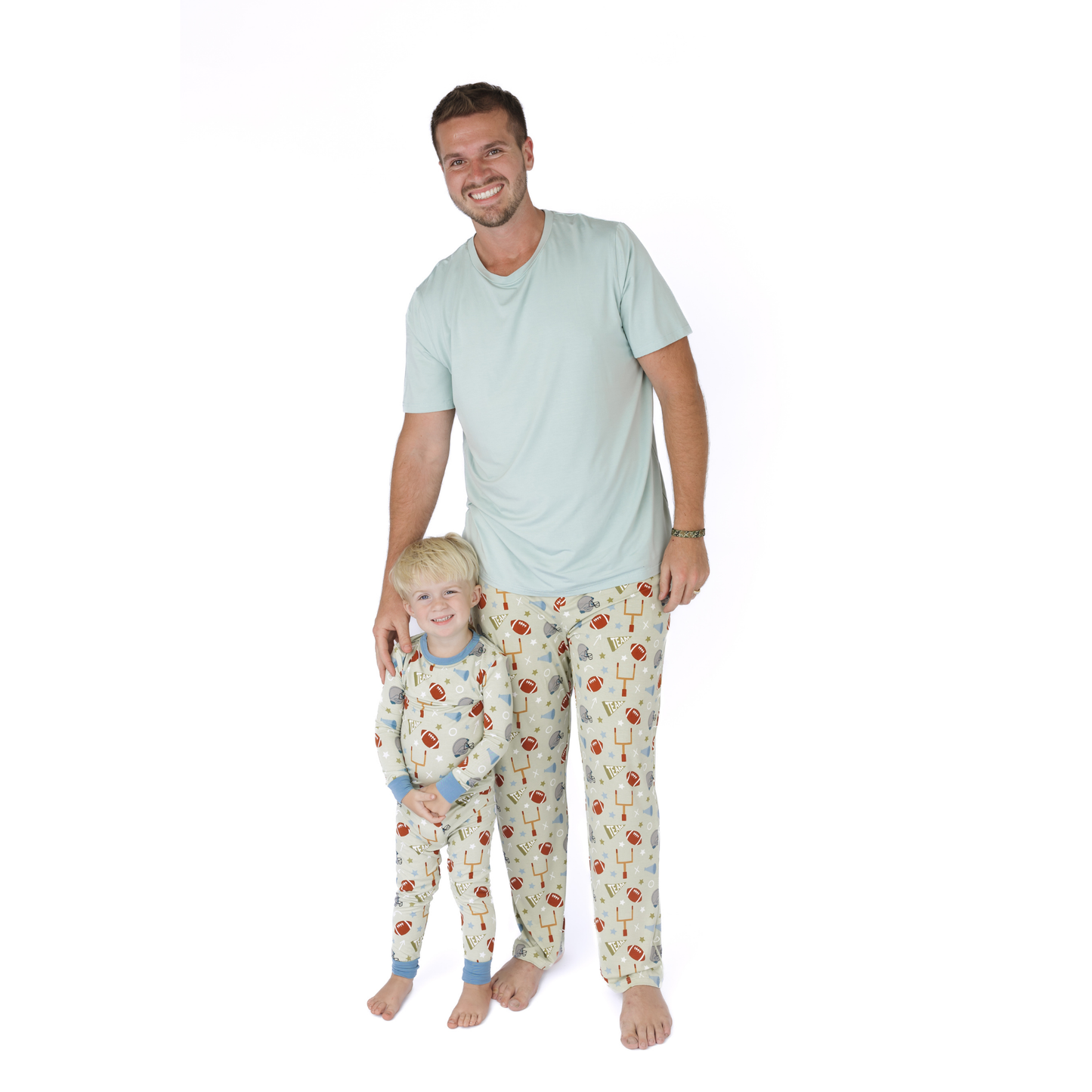 Man and child wearing matching pajamas on a white background
