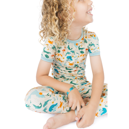 Child wearing a florida theme patterned outfit on a white background