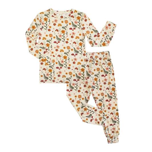 cream pajama set with mushroom print on white background.