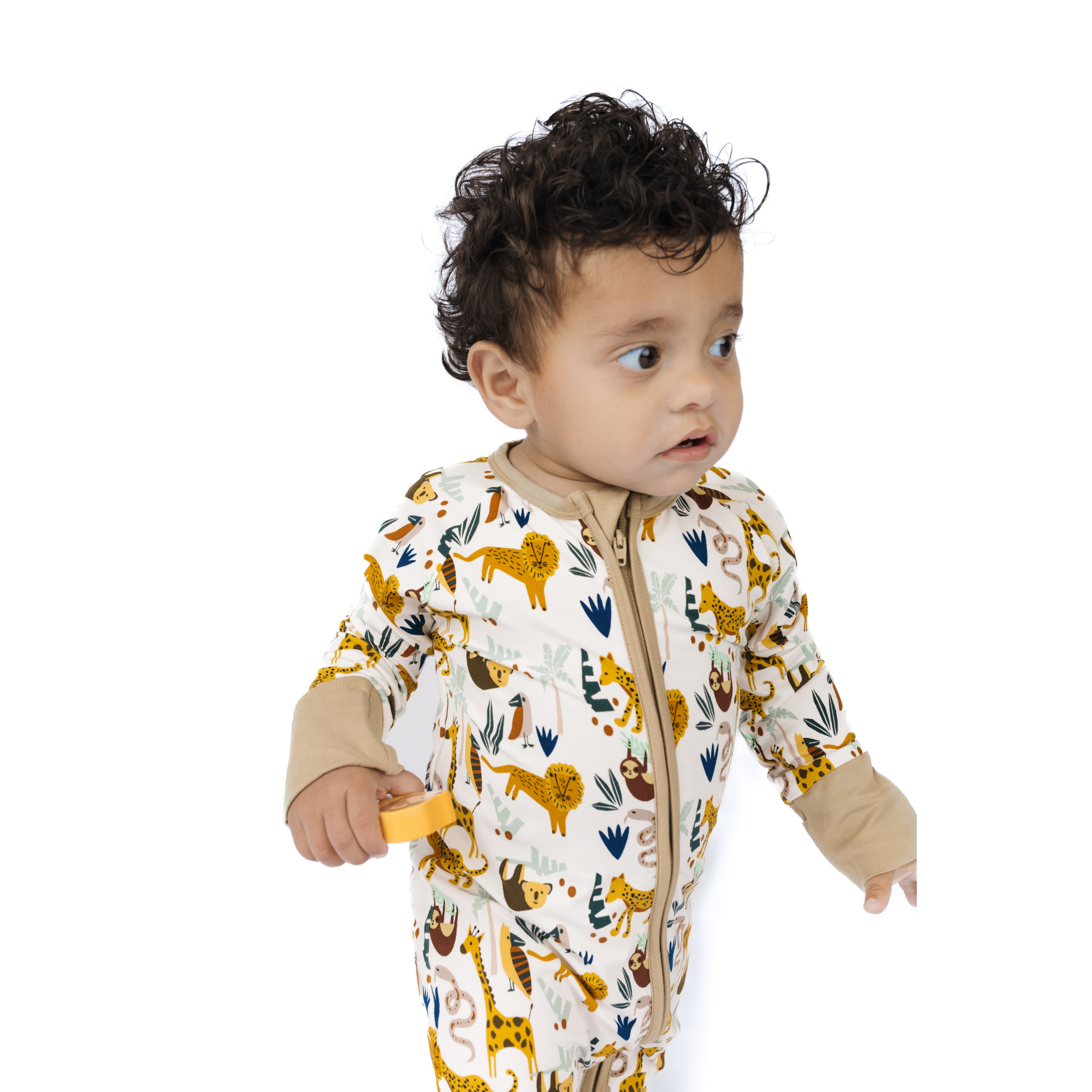 Baby wearing a onesie with animal prints on a white background