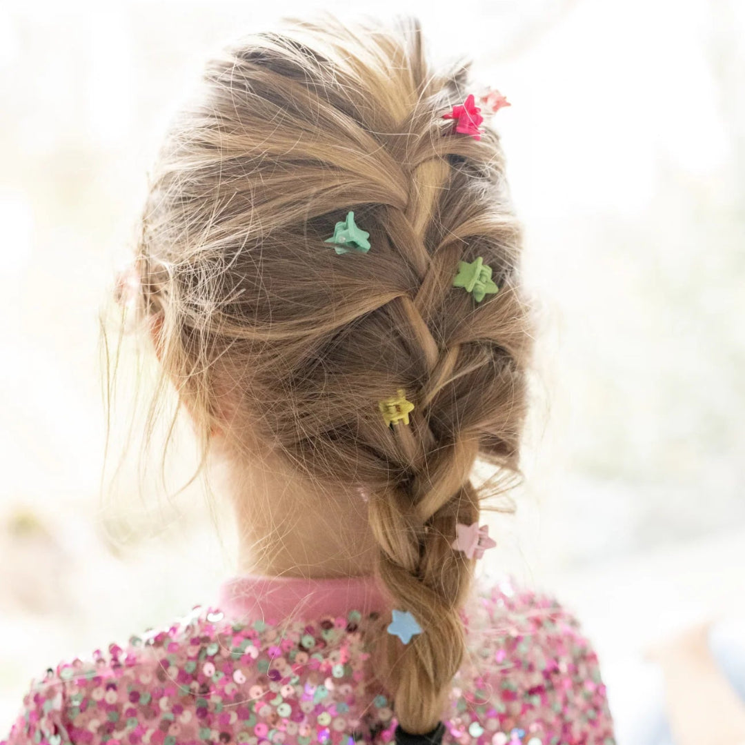 Young girl with braided hair wearing the rainbow colored star mini hair clips from Great Pretenders 