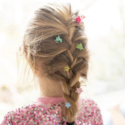 Young girl with braided hair wearing the rainbow colored star mini hair clips from Great Pretenders 
