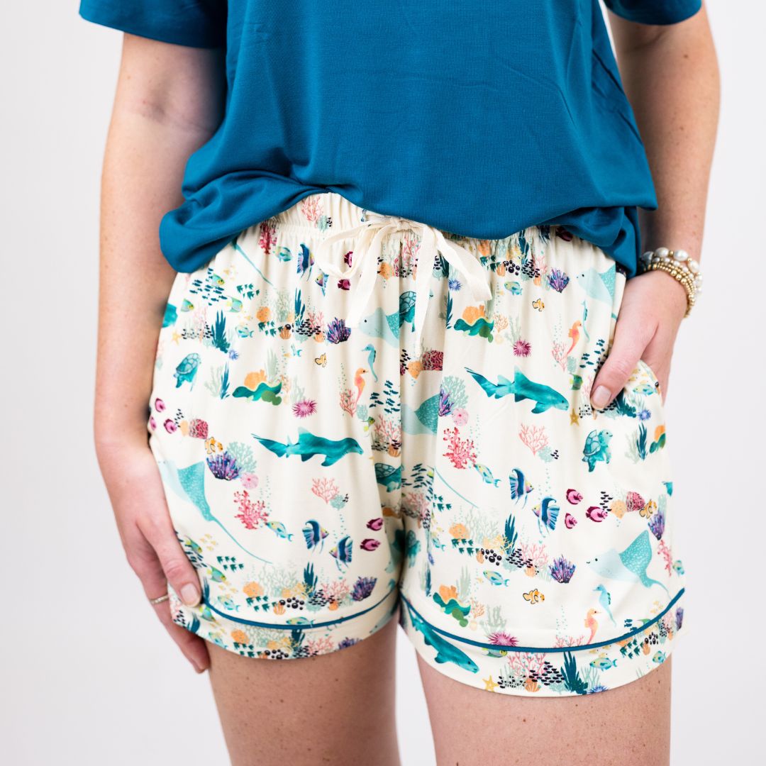 Soft and breathable women’s pajama shorts made from eco-friendly bamboo fabric, featuring a vibrant coral reef print in soothing ocean hues. Designed for ultimate comfort and a relaxed fit, perfect for lounging or sleeping