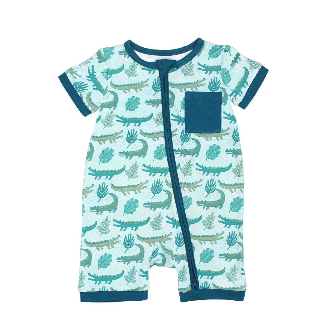 the "later gator" shortie. the "later gator" print has a mix of light and dark green alligators, leaves, and white dots scattered on a teal colored background. 