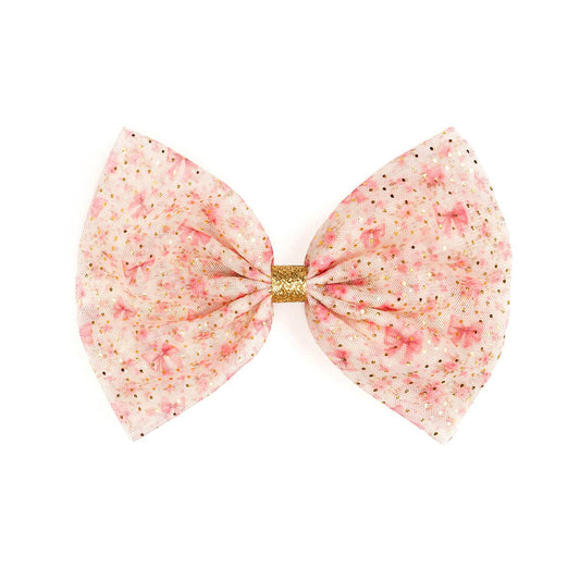 Pink bow with gold center on a white background