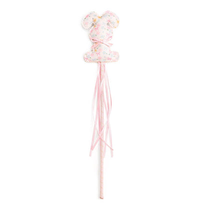 Decorative wand with a bow and tassels on a white background