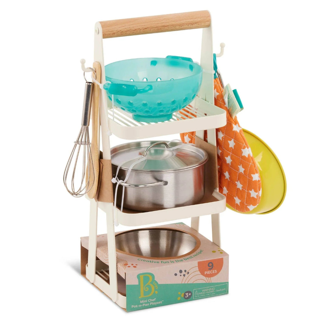 Toy kitchen set with pots, pans, and utensils on a white background