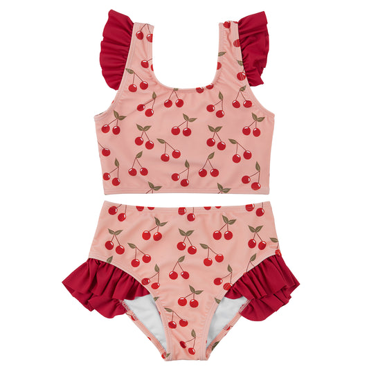 Two-piece swimsuit with cherry pattern on a white background