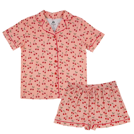 Pink pajama set with cherry pattern on a white background