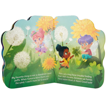Children's book open to a page with fairies and dandelions on a green background