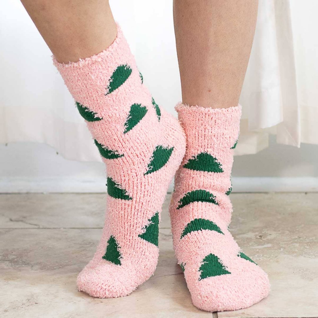 light pink fuzzy socks with christmas trees on them