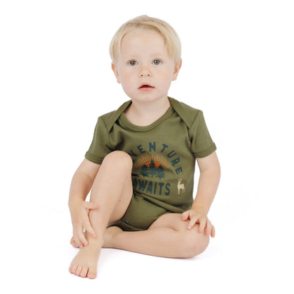 baby wearing forest green bodysuit with adventure awaits graphic