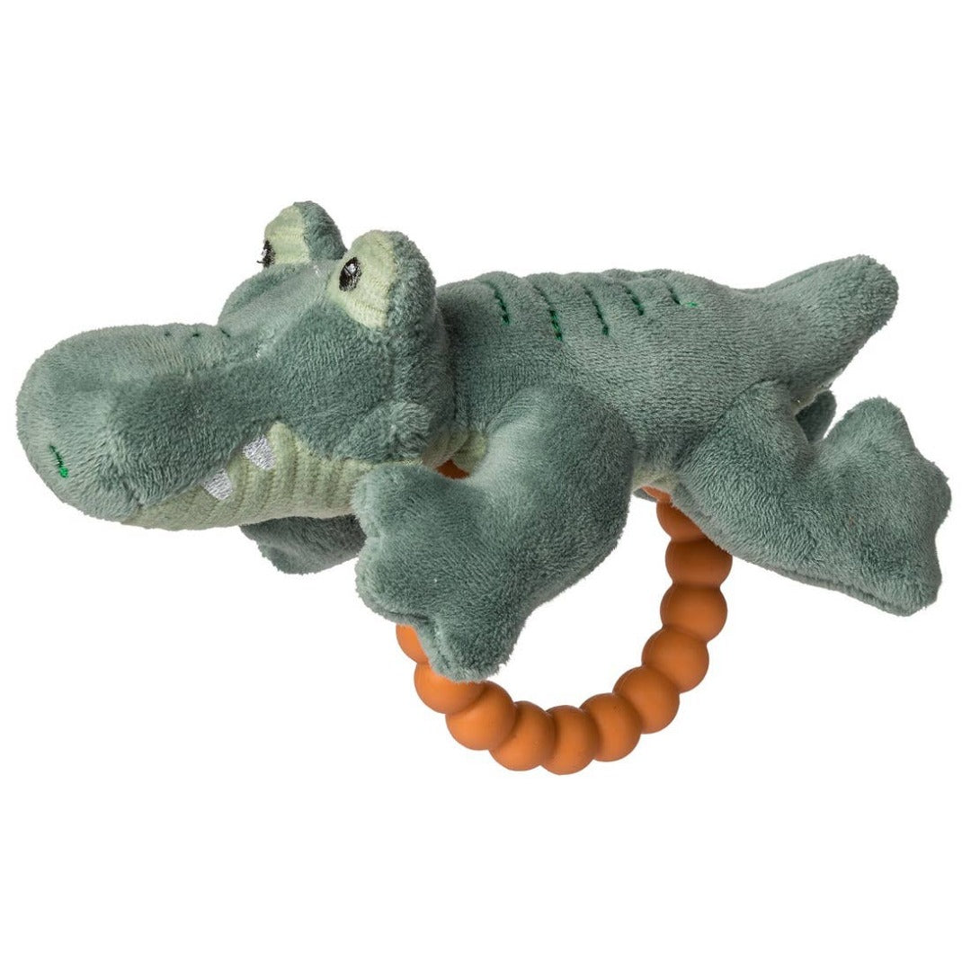 green stuffed alligator toy with orange teething ring attached