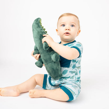 baby boy in his "gator friends" shortie, plays with Andy the Alligator. 