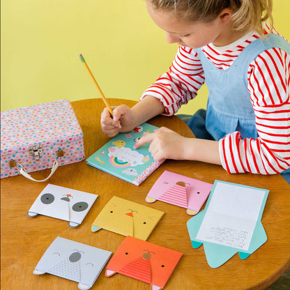 little girl writing on her animal pals stationary