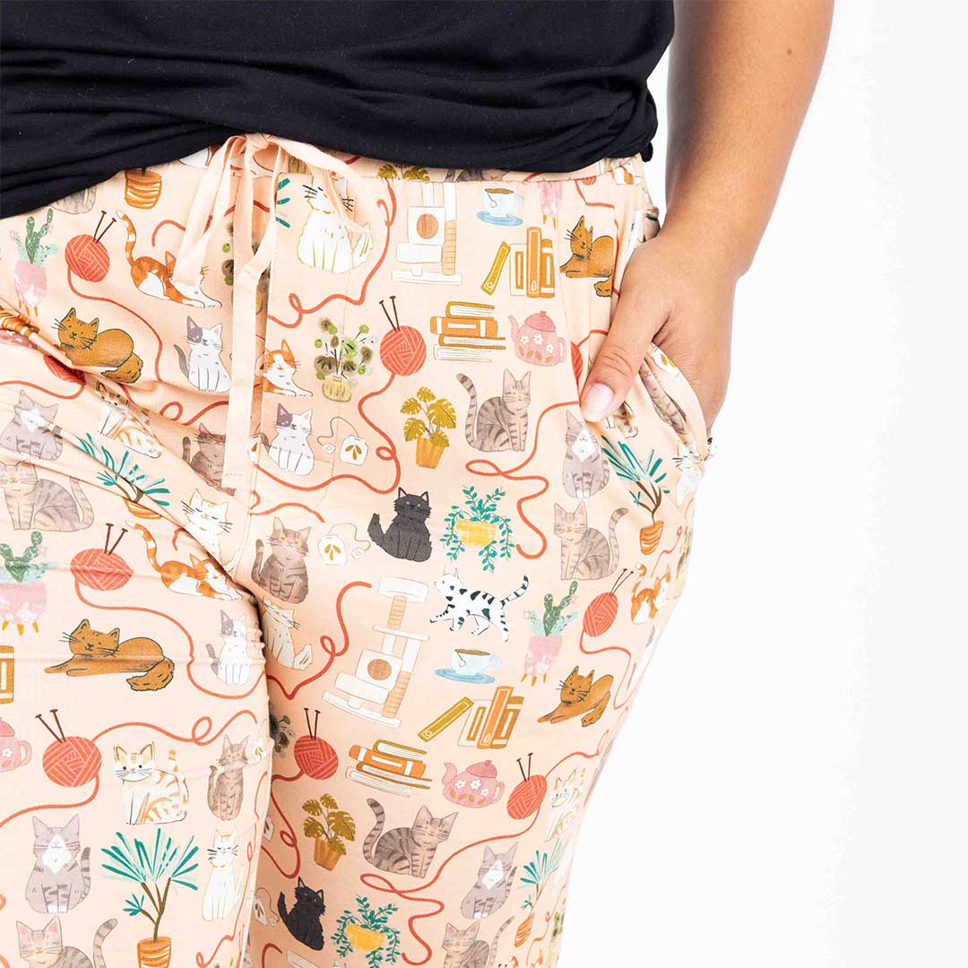 womens hand in pocket of bamboo lounge pants featuring the cat print