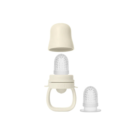 Baby bottle with two different nipples on a white background