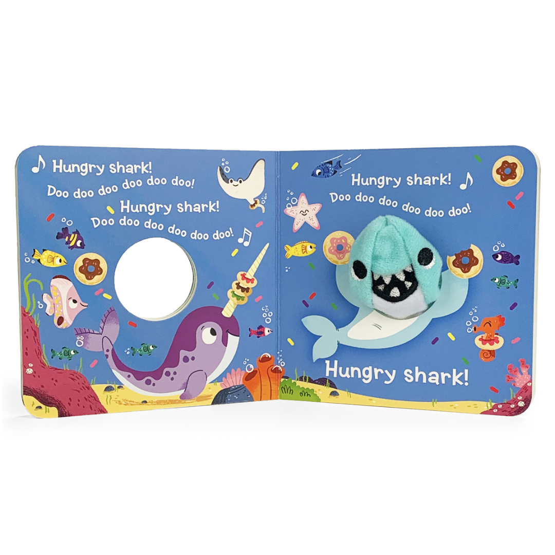Blue shark finger puppet in a board book with multi-colored fish in an underwater scene