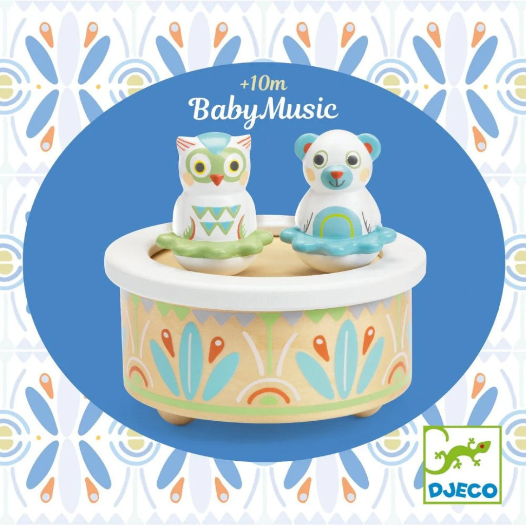 blue and white owl and bear on top of colorful music box