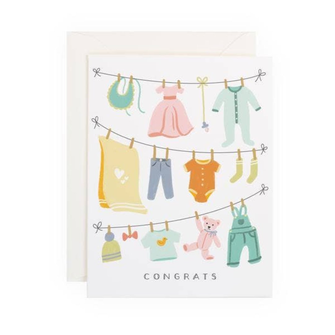 new baby greeting card with baby clothes and stuffed animal