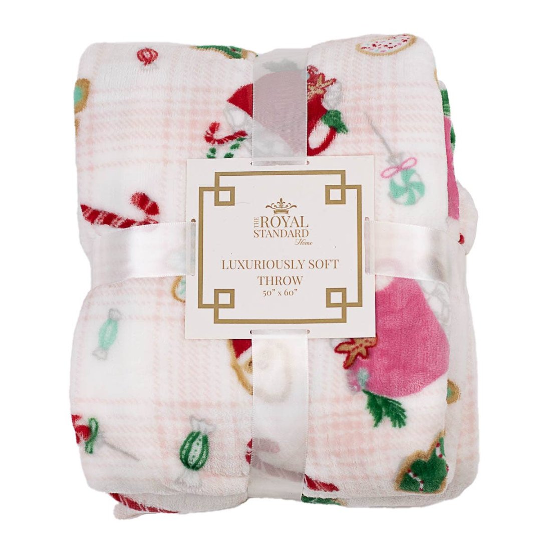 christmas blanket thats light pink with christmas cookies and cups of cocoa on it