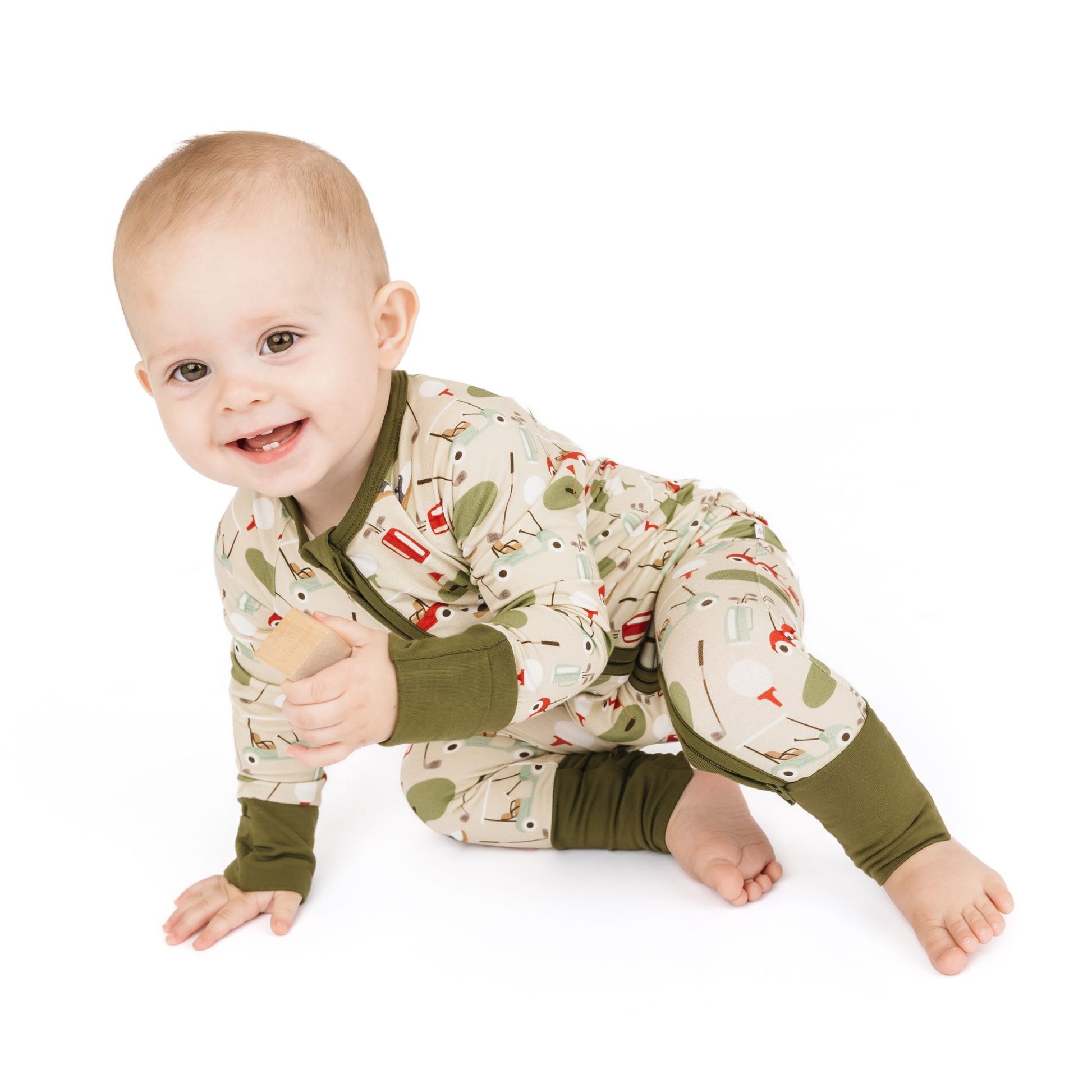 Baby wearing a patterned onesie on a white background