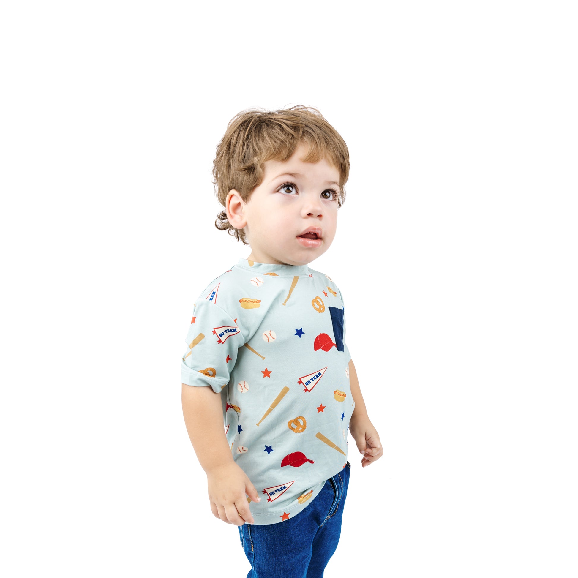 Child wearing a light blue t-shirt with colorful patterns on a white background