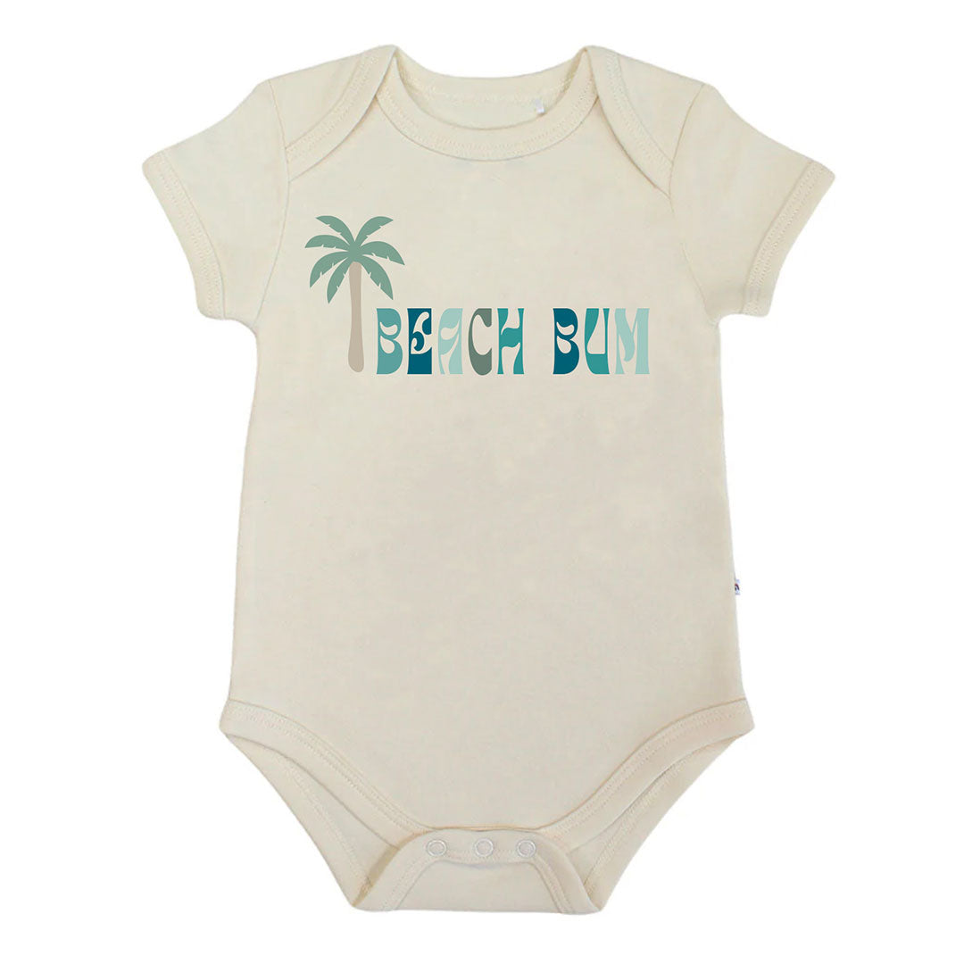 Beige baby bodysuit with 'Beach Bum' and palm tree design on a white background