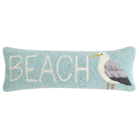 Long blue throw pillow with a seagull image and the word beach