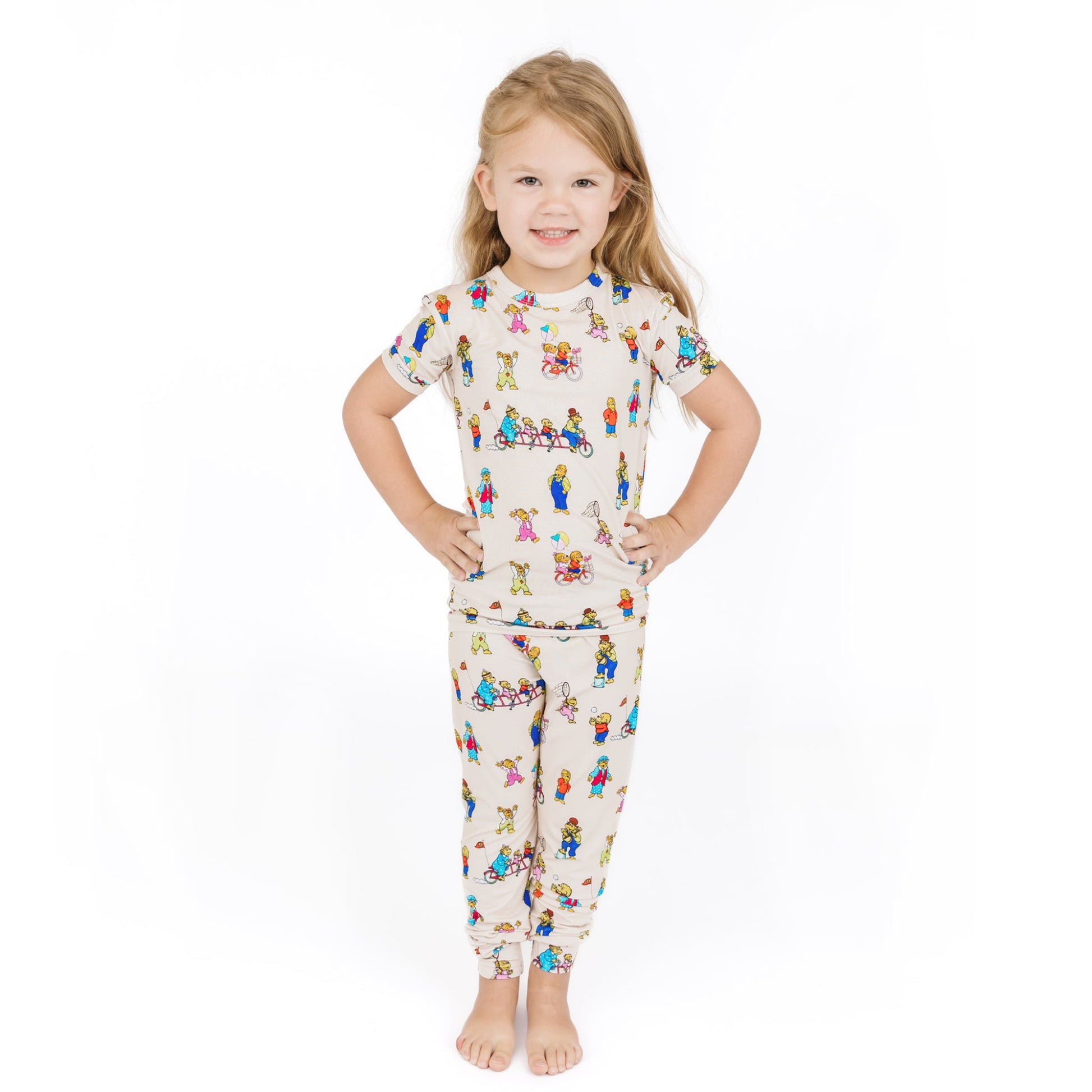 Child wearing a pajama set with a colorful pattern on a white background