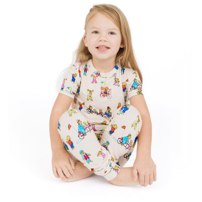 Child wearing a colorful pajama set with cartoon characters on a white background