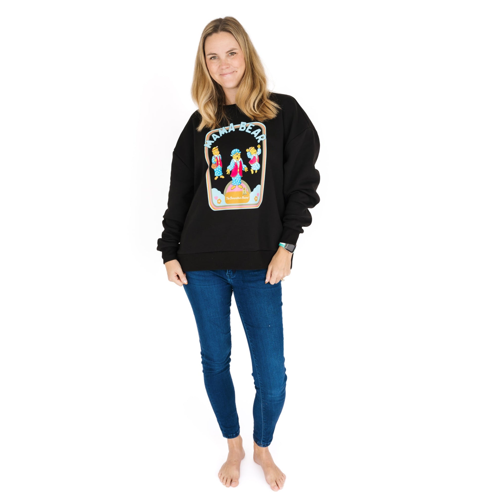 Woman wearing a black sweatshirt with a colorful graphic design on a white background