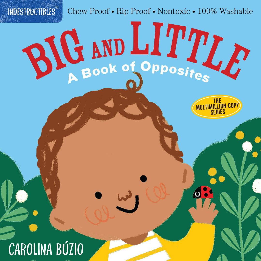 a little boy in a garden holding a lady bug