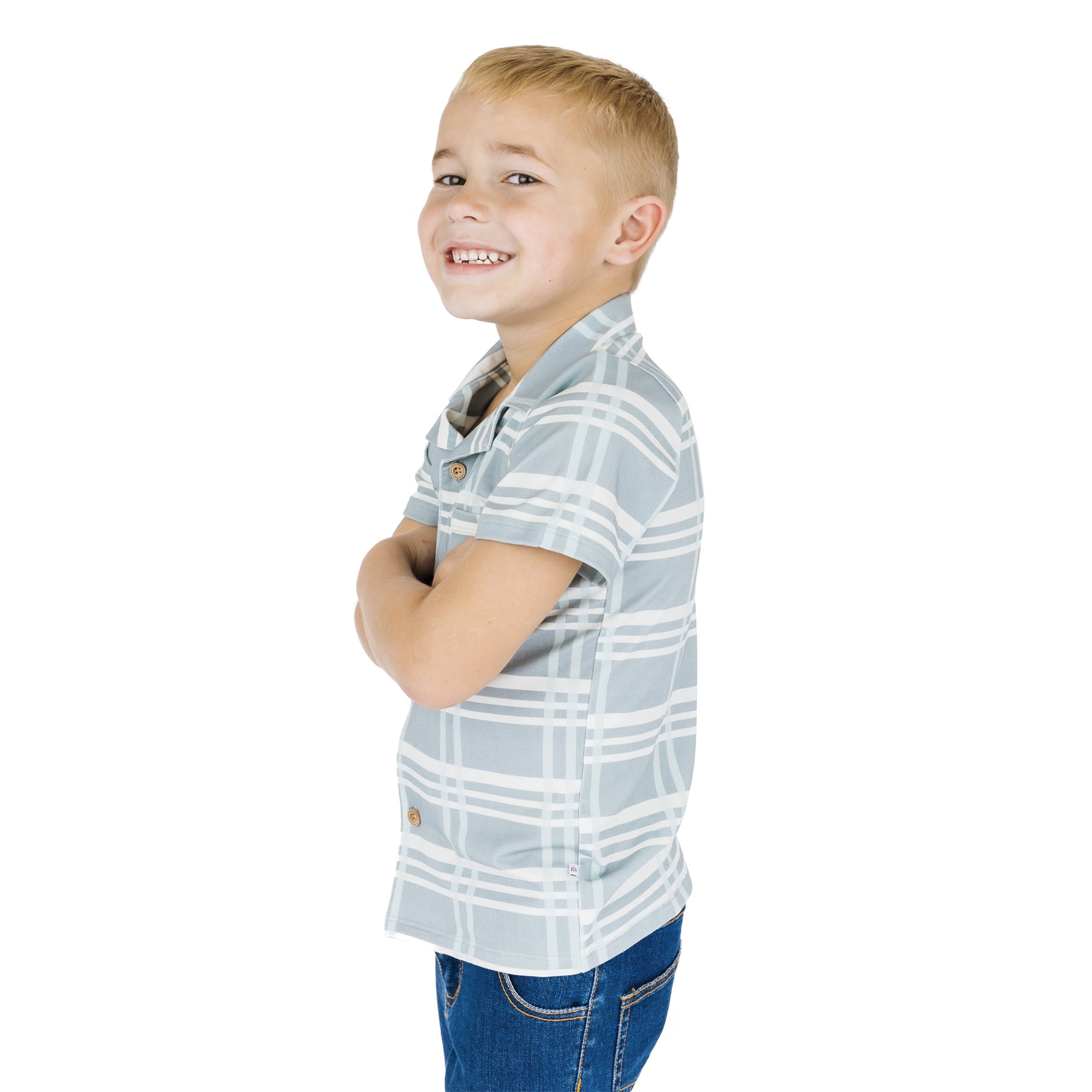 Young boy wearing a plaid shirt and jeans on a white background