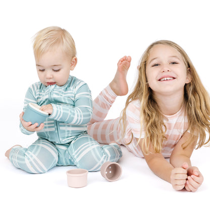 Two children playing with toys on a white background