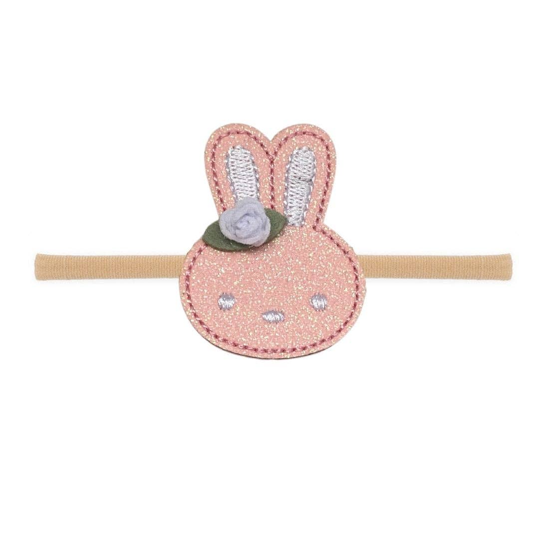 easter headband with a pink glittery easter bunny head on the front