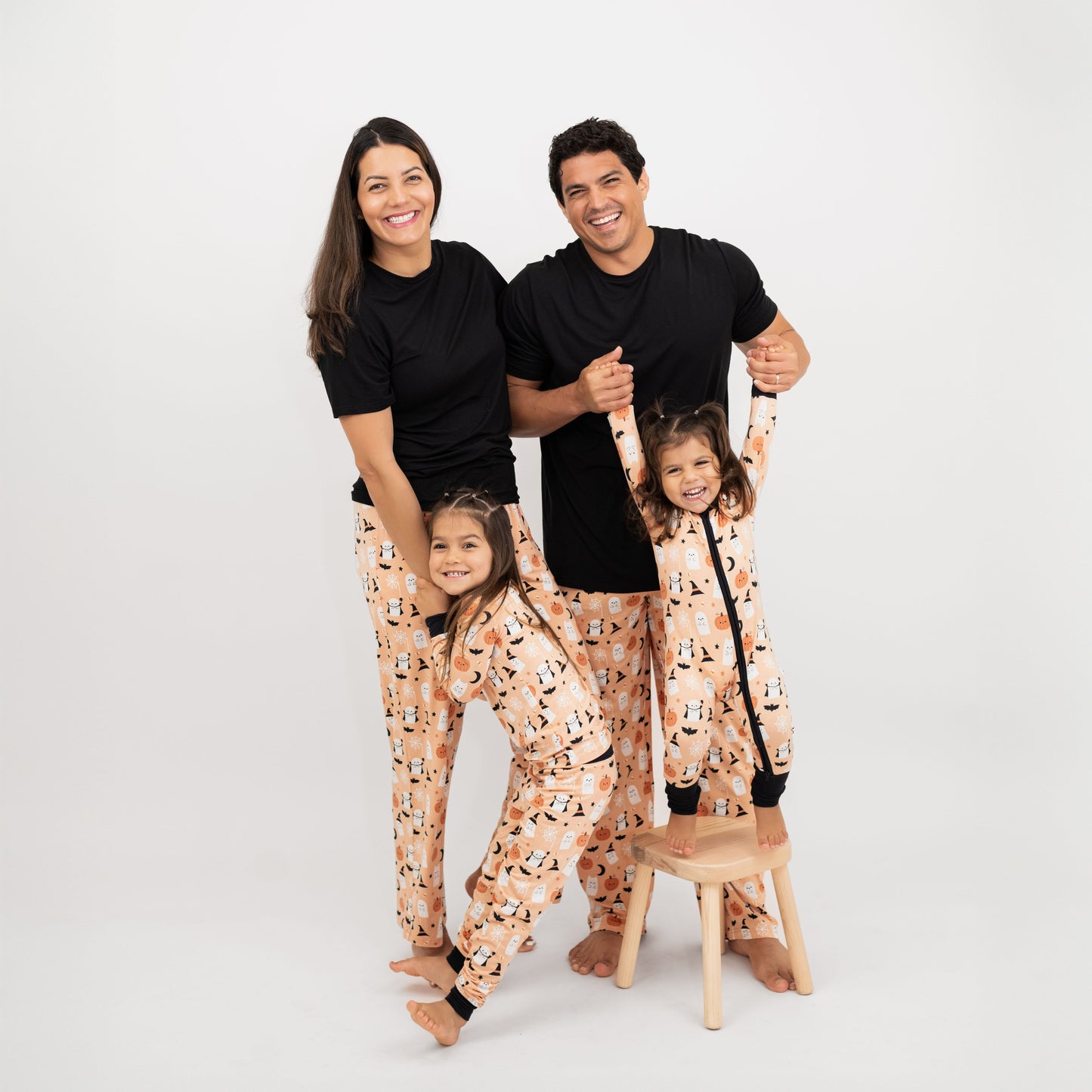 Family wearing matching Boo-Tastic Halloween bamboo pajamas, breathable and hypoallergenic with ghost and pumpkin print.