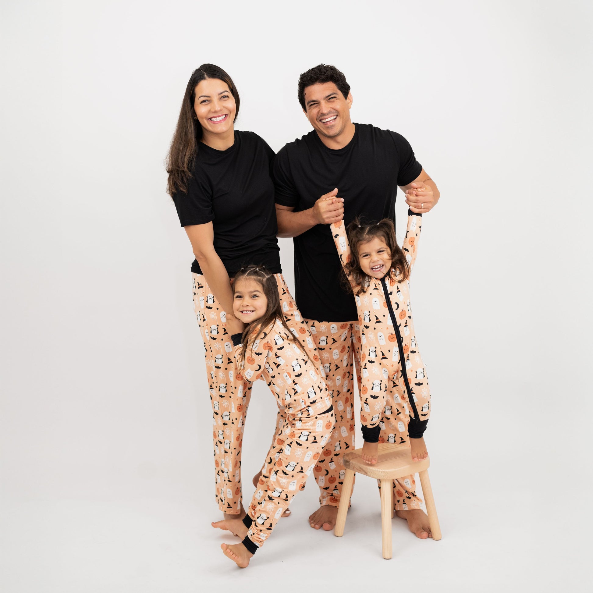 Family wearing matching Boo-Tastic Halloween bamboo pajamas, breathable and hypoallergenic with ghost and pumpkin print.