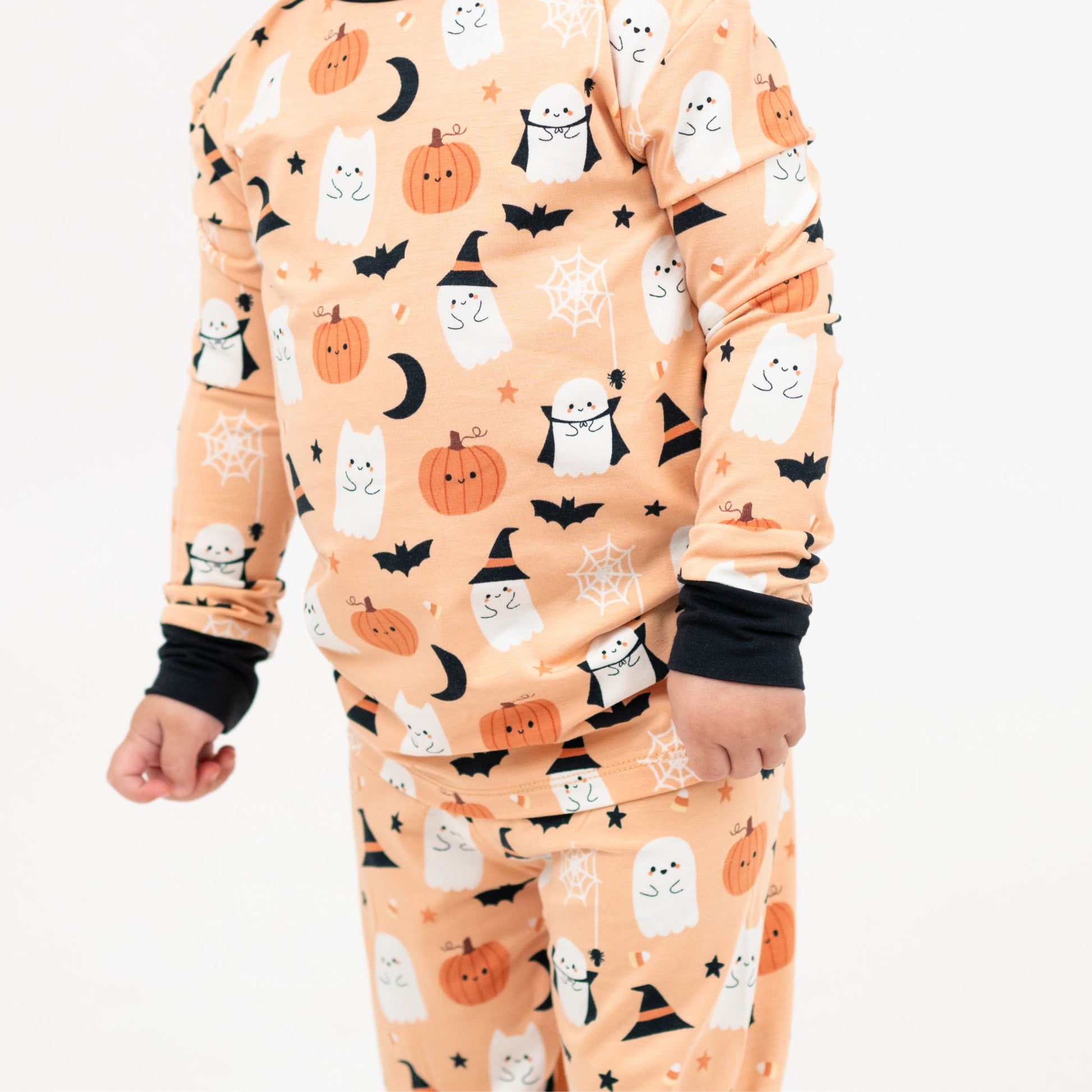 Close-up of Boo-Tastic Halloween bamboo kids pajamas showing ghost, pumpkin, bat, and witch hat print.